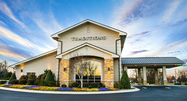A street-level view of Traditions bank, with beautiful landscaping and an accommodating drive thru, in Priceville, AL.